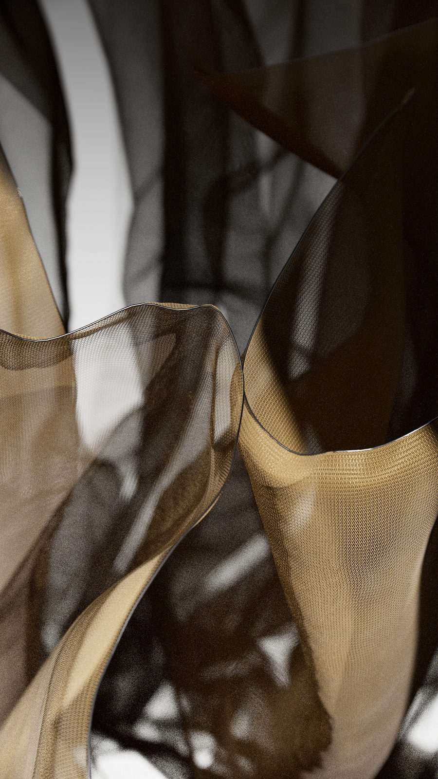 Close-up of black and gold mesh fabric overlapping in soft light, a Vellum cloth simulation rendered in Karma.